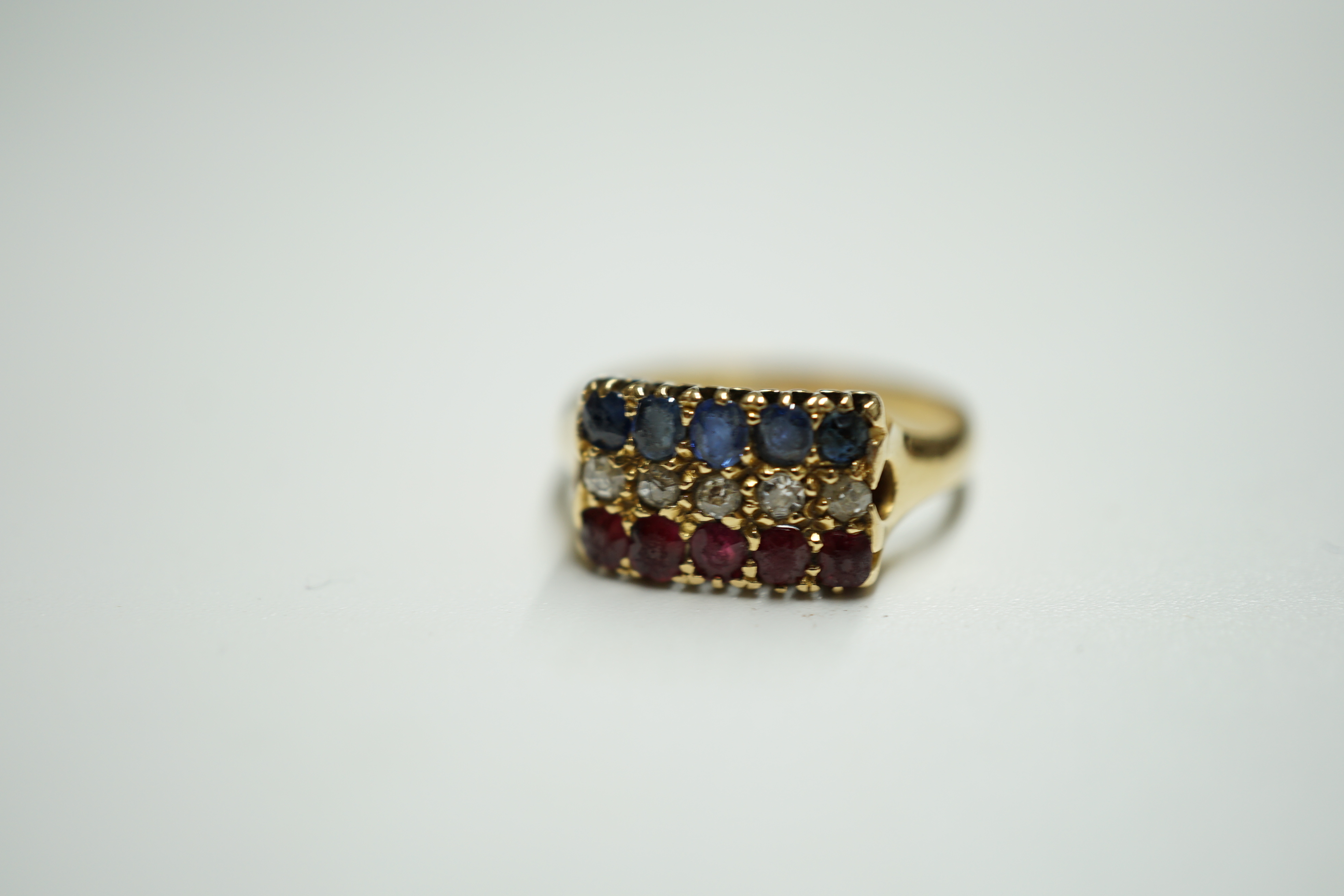 An early 20th century gold and three row sapphire, ruby and diamond set ring, size M, gross weight 3.1 rams. Condition - poor to fair